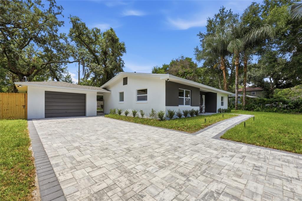 A single-story house with a white and gray exterior, a paved driveway, and a garage — 238 PRESCOTT DRIVE, ORLANDO, FL