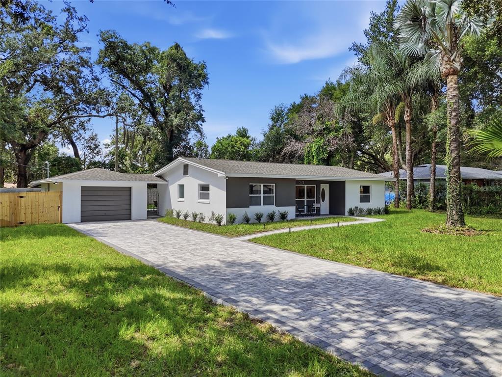 A single-story house with a gray garage, white and gray exterior, and a paved driveway — 238 PRESCOTT DRIVE, ORLANDO, FL