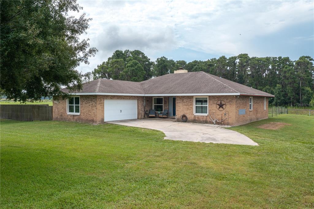 A single-story brick house with a two-car garage and a concrete driveway — 1755 BETH LANE, WINTER HAVEN, FL
