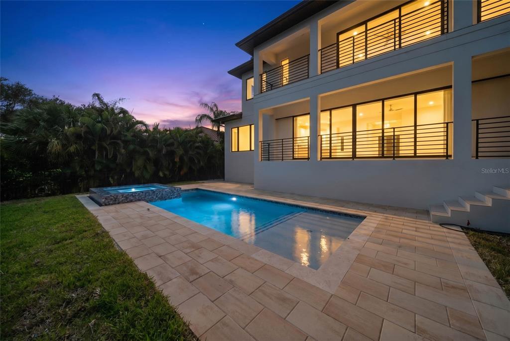 A modern two-story house exterior features a rectangular swimming pool with an attached hot tub — 626 BUTTONWOOD DRIVE, LONGBOAT KEY, FL