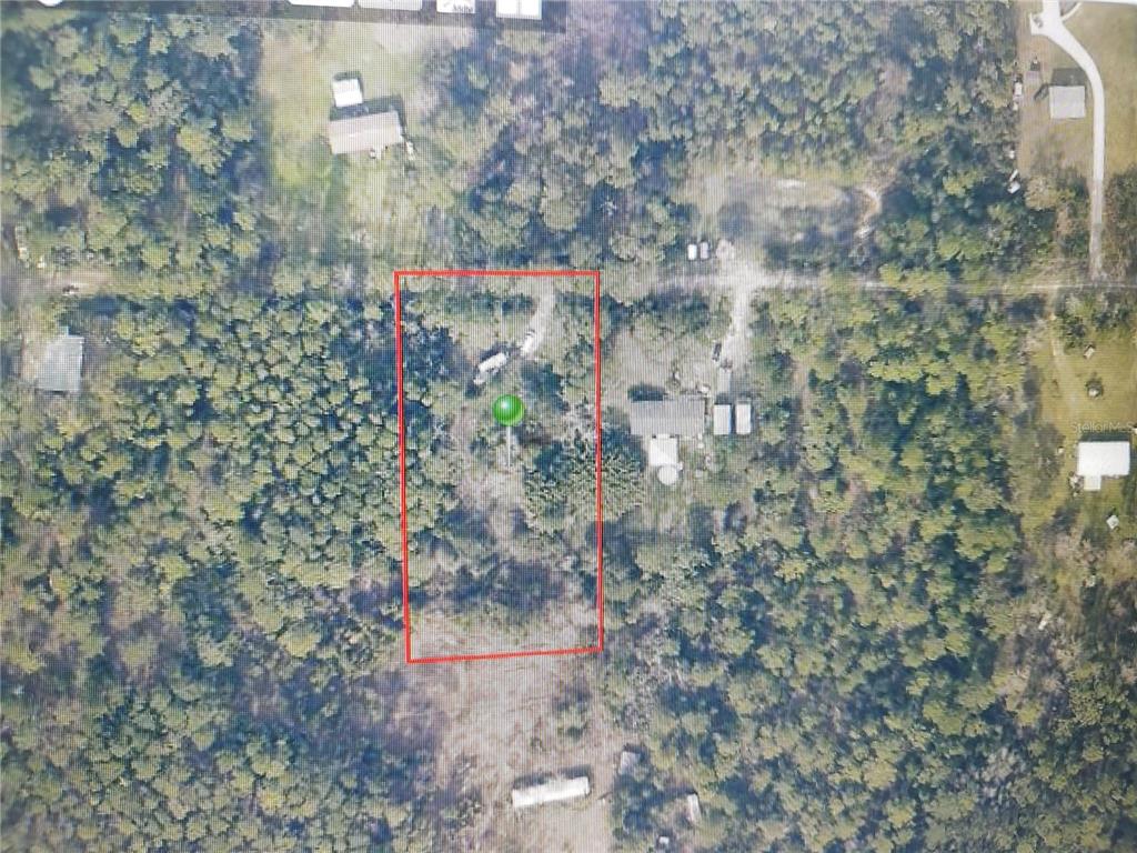 An aerial view of a rectangular plot of land outlined in red within a wooded area — 4650 HERIN DRIVE, NEW SMYRNA BEACH, FL