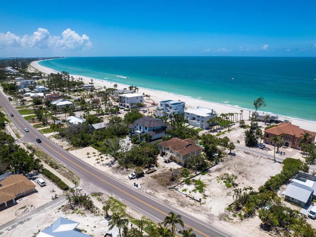 An aerial view of a coastal road lined with houses leading to a sandy beach — 6549 GULF OF MEXICO DRIVE, LONGBOAT KEY, FL