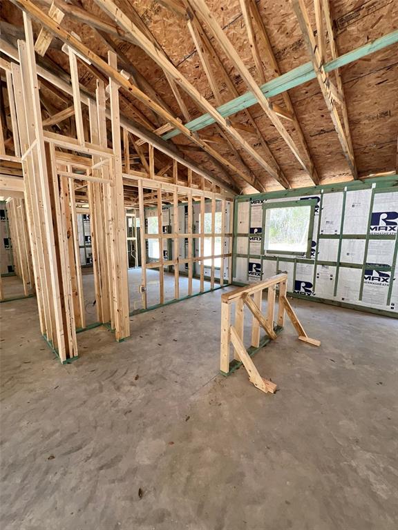 An interior view of a house under construction showing exposed wood framing and wall insulation — 3 GUAVA PASS RUN, OCKLAWAHA, FL