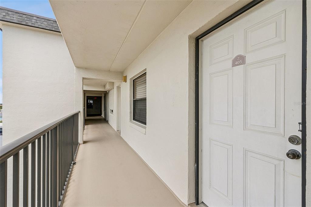 An exterior hallway with a white door labeled 405 and a metal railing — 2700 OCEAN SHORE BOULEVARD UNIT 405, ORMOND BEACH, FL