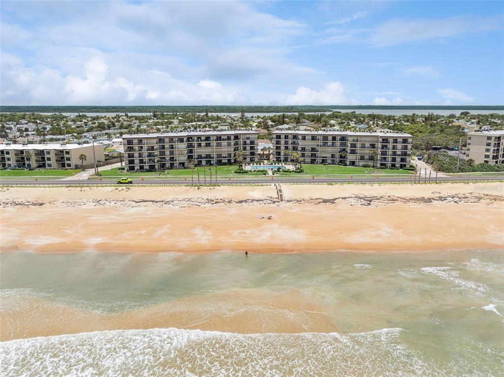 An aerial view of a beachfront condominium complex with a pool and a sandy beach — 2700 OCEAN SHORE BOULEVARD UNIT 405, ORMOND BEACH, FL