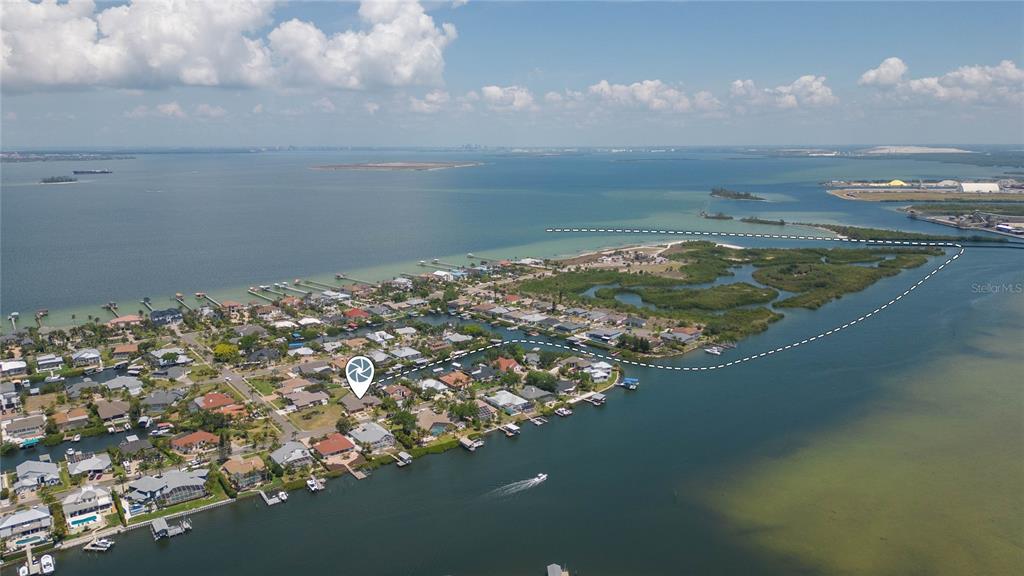 An aerial view shows a residential neighborhood on a peninsula surrounded by water — 6602 SEABIRD WAY, APOLLO BEACH, FL