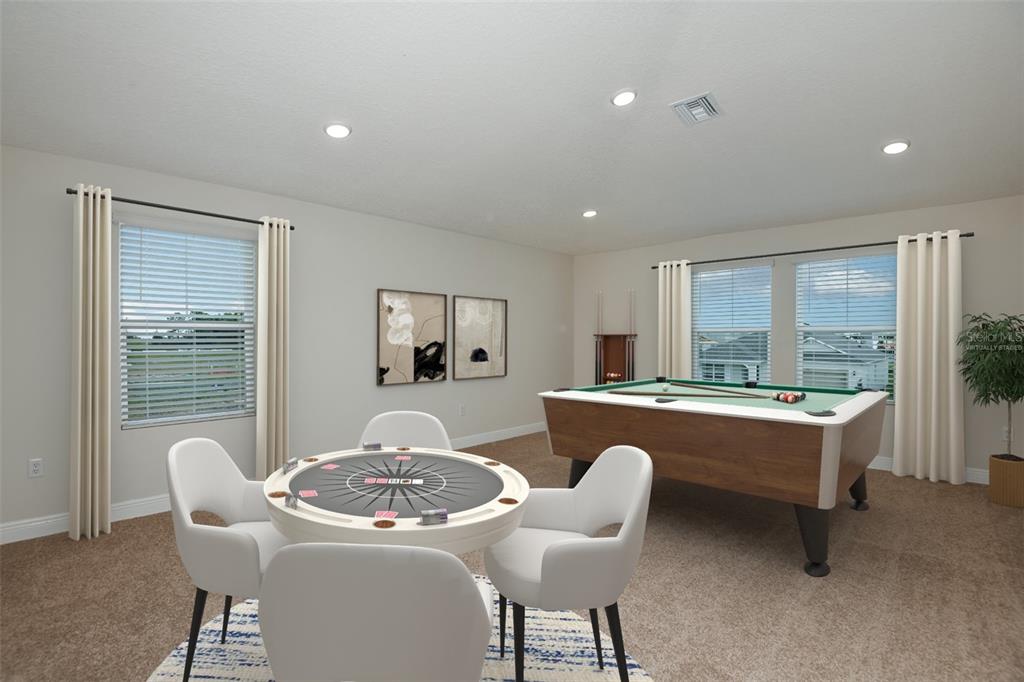 A game room features a pool table, a card table with four chairs, and carpeting — 31717 BIENVILLE LANE, WESLEY CHAPEL, FL