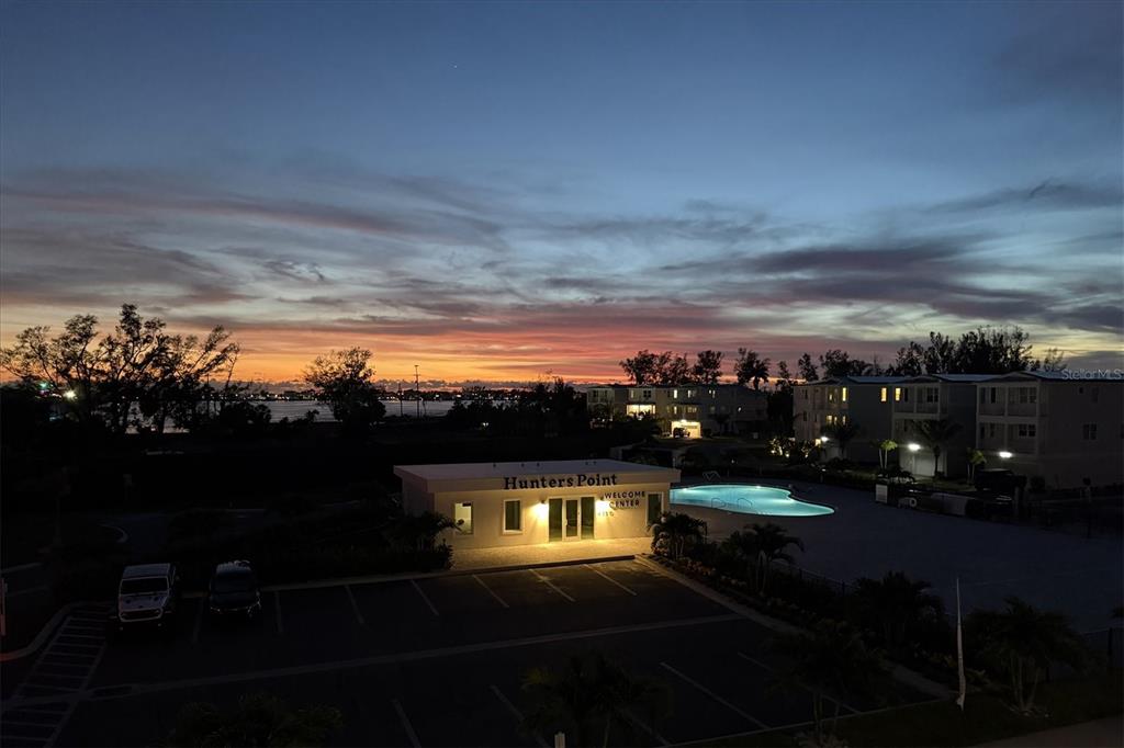 An exterior view of the Hunters Point welcome center and pool at sunset — 4357 MARINA VIEW WAY, CORTEZ, FL