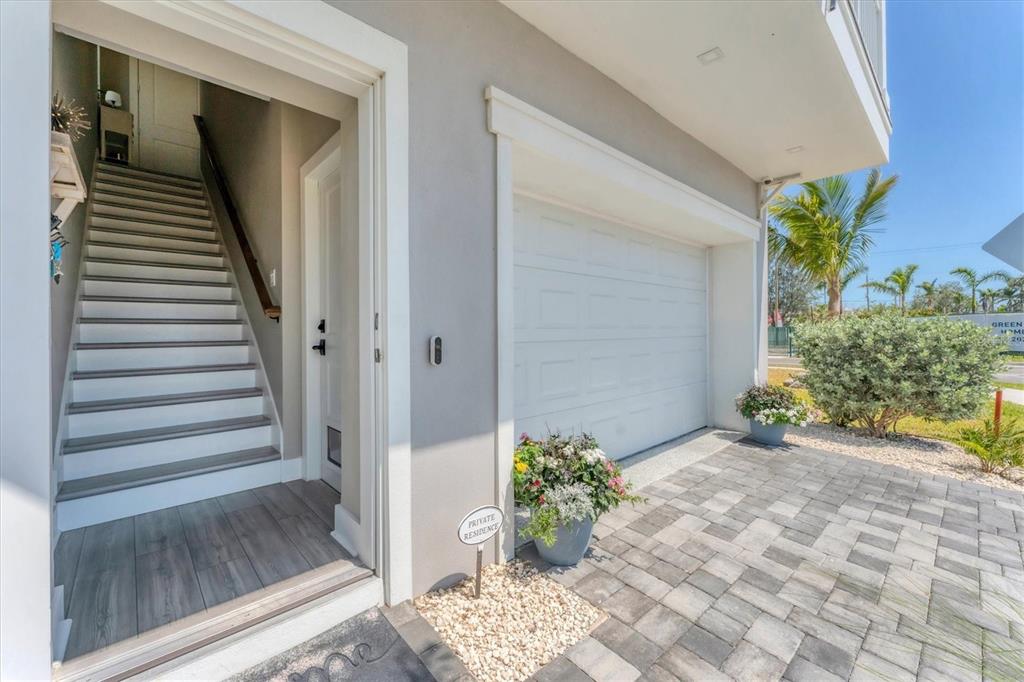 An exterior view shows a garage, a staircase leading to an entrance, and landscaping — 4357 MARINA VIEW WAY, CORTEZ, FL