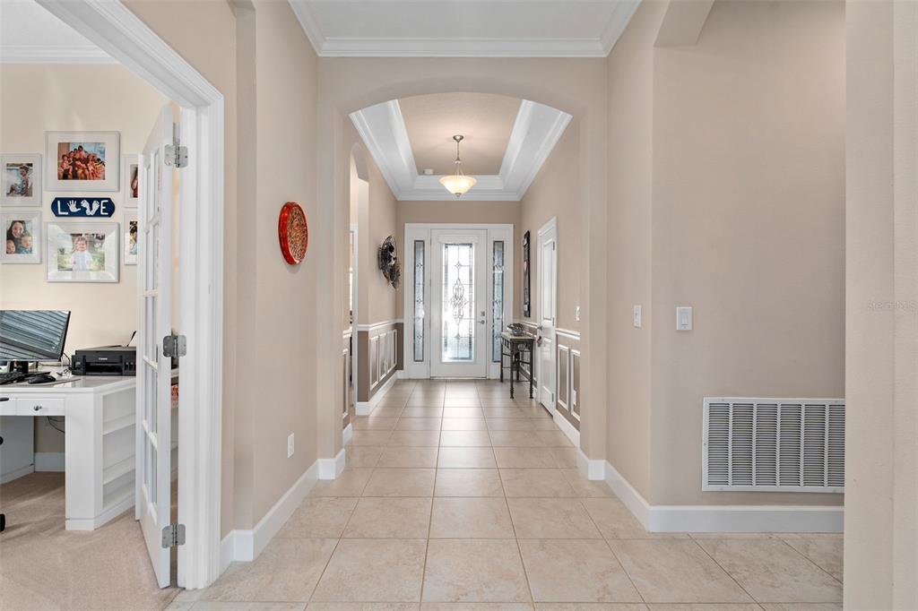 A tiled entryway features a tray ceiling, a glass-paneled front door, and an adjacent office — 1197 ESPERANZA RIDGE ROAD, CLERMONT, FL