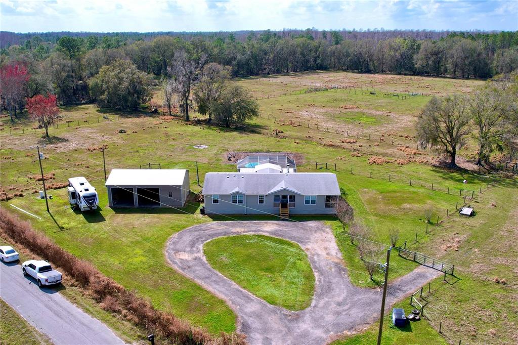An aerial view shows a house with a pool, a detached garage, and an RV — 14890 CR 757, WEBSTER, FL