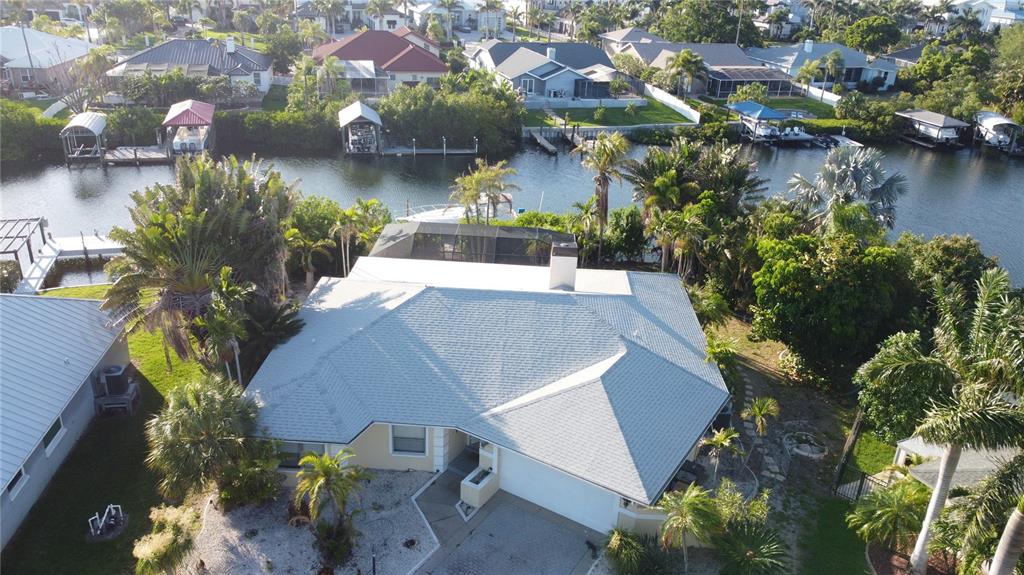 An aerial view of a single-story house with a gray roof near a canal — 6612 BLACKFIN WAY, APOLLO BEACH, FL