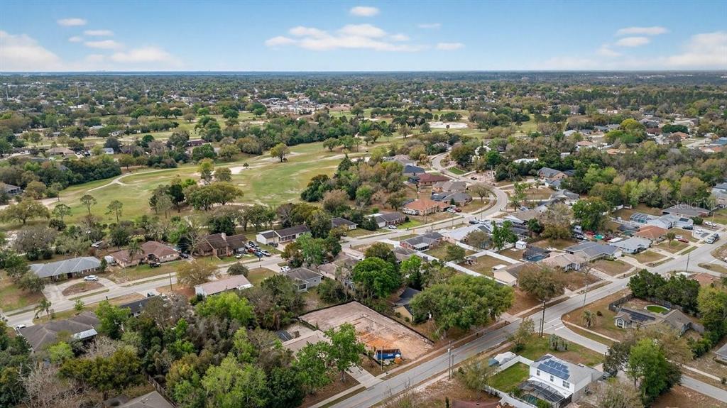 A single-story white house with a two-car garage and a front lawn — 1280 S SEAGATE DRIVE, DELTONA, FL