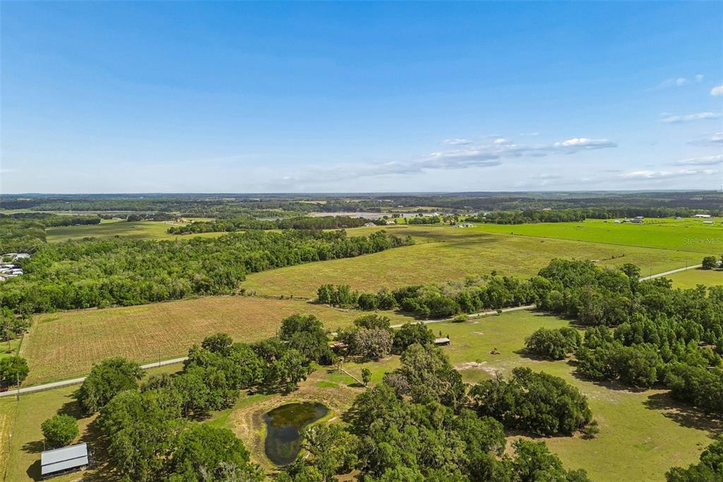 An aerial view shows a large rural property with fields, trees, and a small pond — BAYHEAD ROAD Lot 6-9, DADE CITY, FL