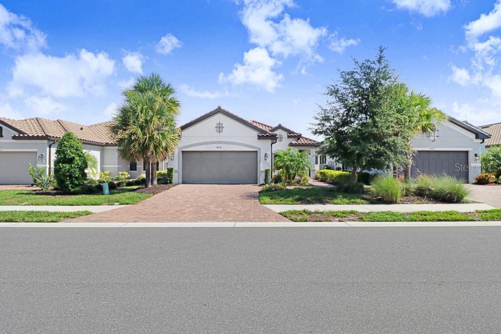 A single-story suburban house with a paved driveway, a two-car garage, and landscaping — 4634 CRESTPOINT WAY, PALMETTO, FL