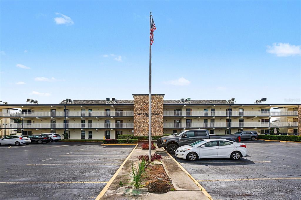 A three-story apartment building with a stone facade and a parking lot in front — 6100 12TH STREET S UNIT 313, ST PETERSBURG, FL