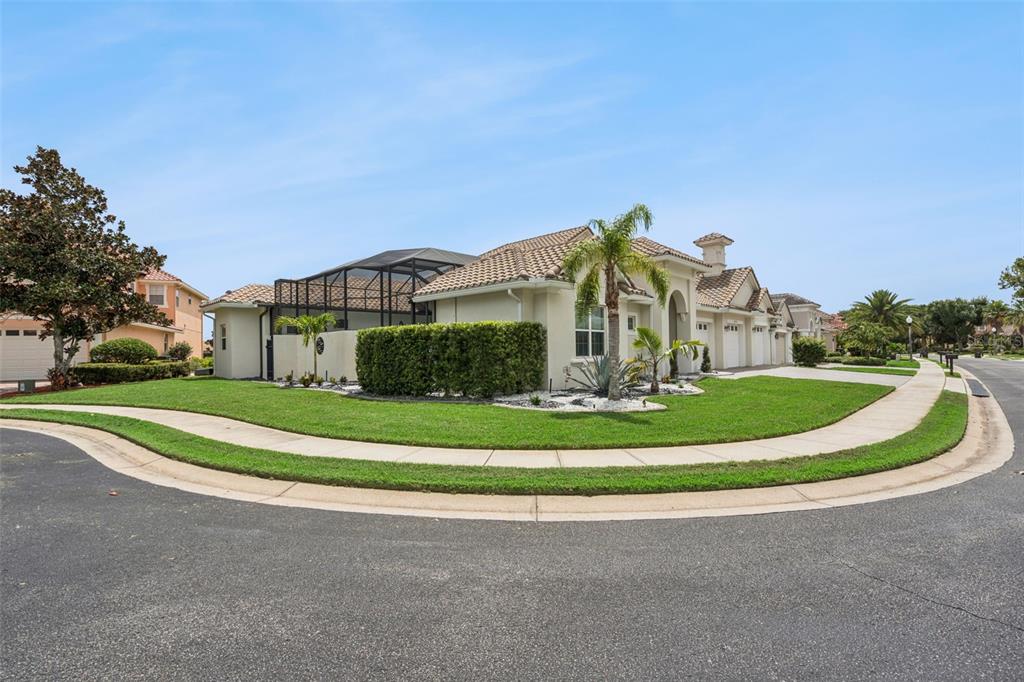 A corner lot house features a screened-in pool enclosure, manicured landscaping, and a paved driveway — 2270 CALLAWAY COURT, DAVENPORT, FL