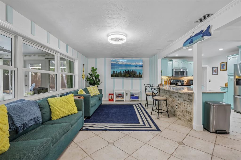 An entryway features a wood front door, white sliding closet doors, and tiled flooring — 13801 87TH AVENUE, SEMINOLE, FL
