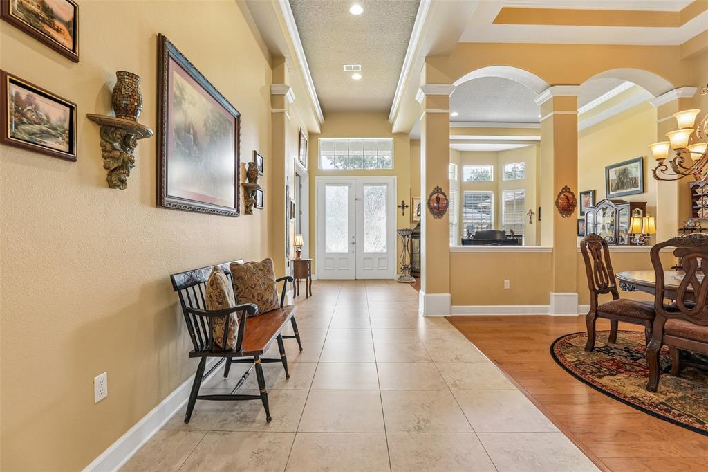 A tiled entryway leads to a front door, with a dining area to the right — 2431 PONKAN SUMMIT DRIVE, APOPKA, FL