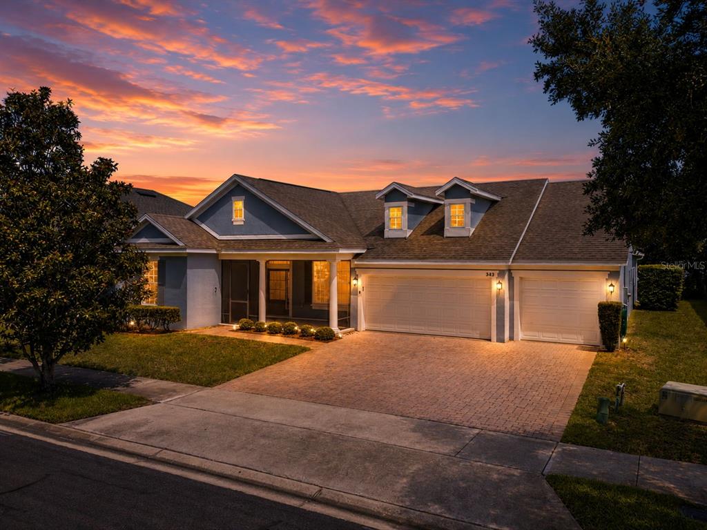 An aerial view of suburban houses along a lake at sunset — 589 BLUE CYPRESS DRIVE, GROVELAND, FL