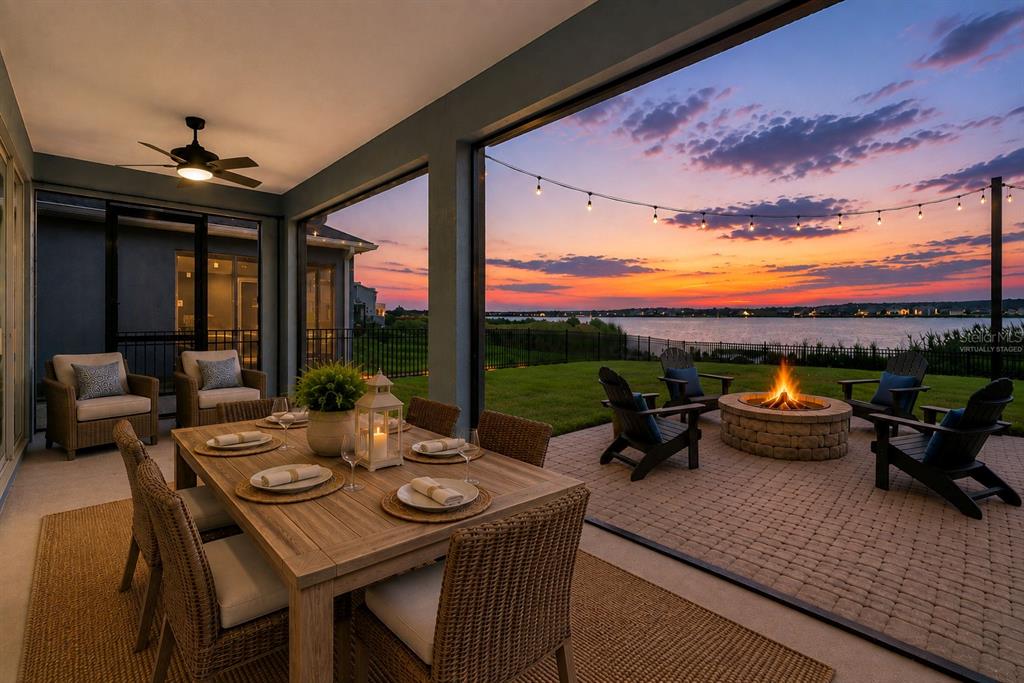 A blue house with a brick driveway and two dormer windows at sunset — 589 BLUE CYPRESS DRIVE, GROVELAND, FL