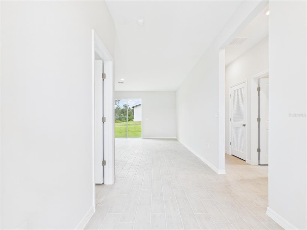 A single-story house with a gray garage and stone accents sits on a grassy lot — 16090 SW 42ND TERRACE, OCALA, FL