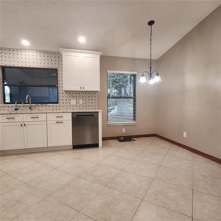 This image shows a kitchen with white floor-to-ceiling cabinets and tile flooring — 2805 LAKE TOHOPEKALIGA BOULEVARD, KISSIMMEE, FL
