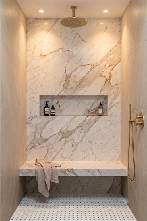 A walk-in shower features marble walls, a built-in bench, a niche, and gold-toned fixtures — 826 32ND AVENUE N, ST PETERSBURG, FL