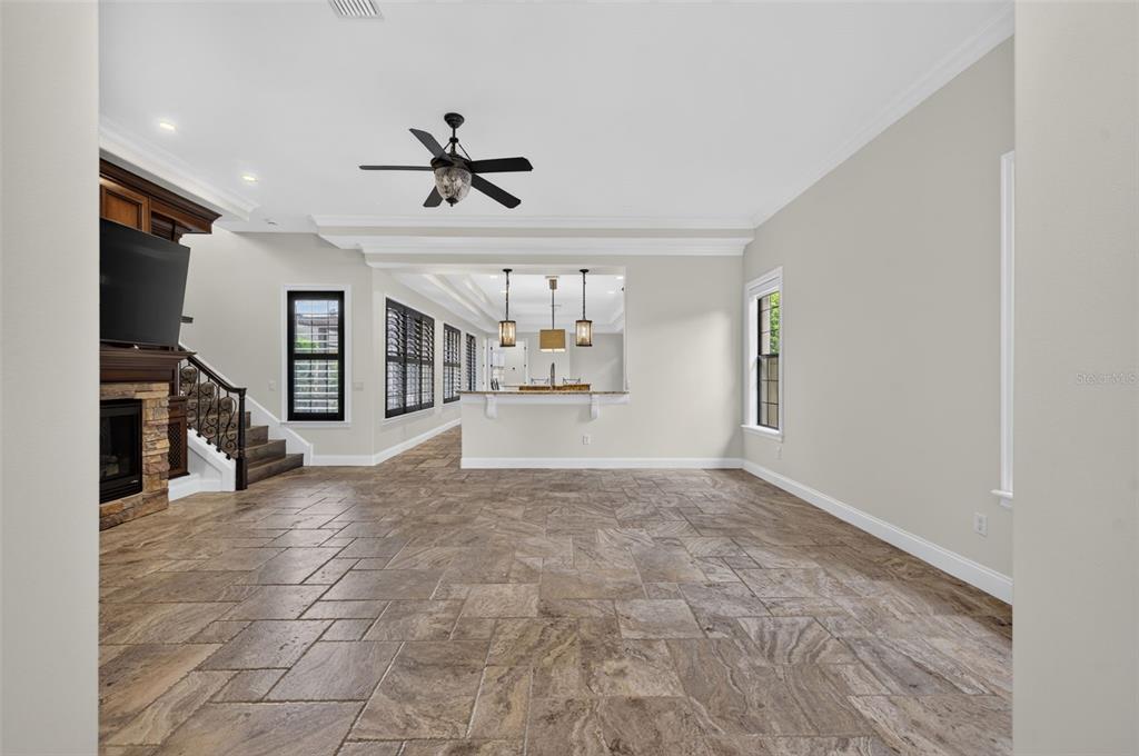 A living room with tile flooring, a stone fireplace, and a breakfast bar — 1570 PALMER AVENUE, WINTER PARK, FL