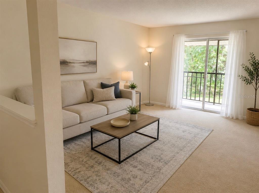 An empty dining area features beige carpet, a light fixture, and a granite breakfast bar — 4312 HECTOR COURT UNIT 4, ORLANDO, FL