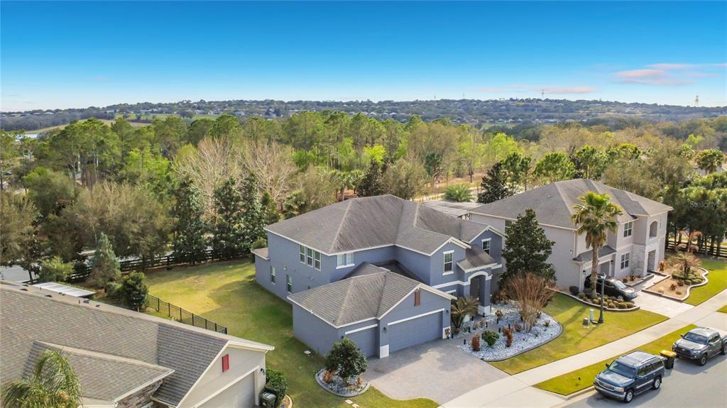 An aerial view of a two-story blue house with a garage and a large yard — 539 TIMBERVALE TRAIL, CLERMONT, FL
