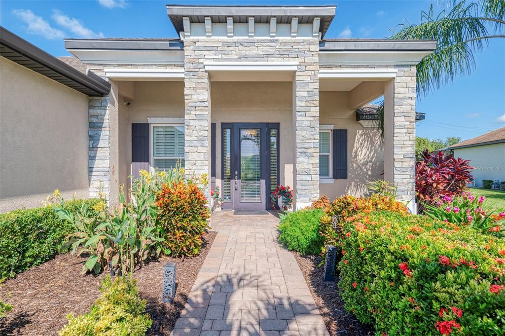 An aerial view of a single-story suburban house with a paved driveway and palm trees — 708 ROSEMARY CIRCLE, BRADENTON, FL