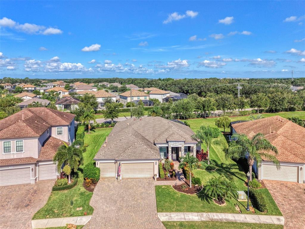 The front exterior of a house features a stone-accented entryway and a paved walkway — 708 ROSEMARY CIRCLE, BRADENTON, FL