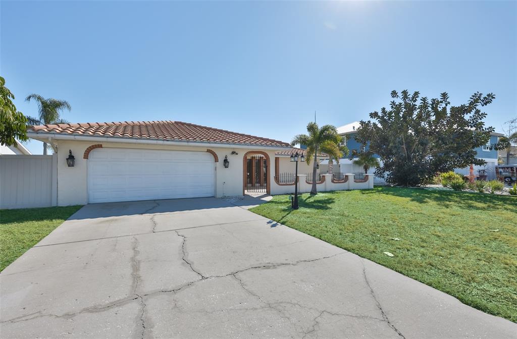 A single-story house with a tiled roof, a two-car garage, and a concrete driveway — 6523 KING PALM WAY, APOLLO BEACH, FL