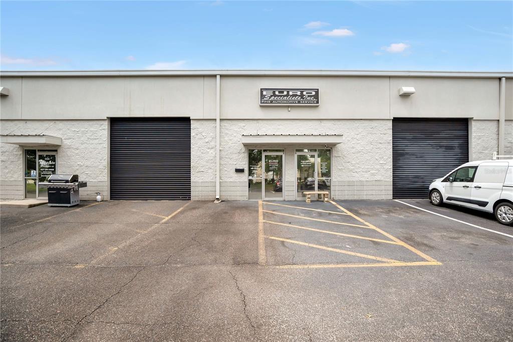 The exterior of a commercial building features two large roll-up doors and a central entrance — 2350 S US HIGHWAY 17 92, LONGWOOD, FL