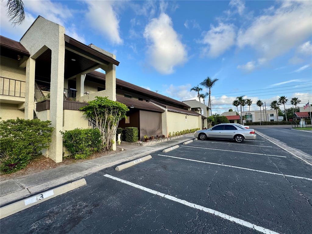 A two-story building with a parking lot in the foreground under a blue sky — 1100 E BAY DRIVE UNIT 3, LARGO, FL
