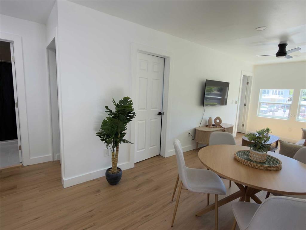 A dining area with a round table and chairs sits adjacent to a living room — 612 N HAMPTON AVENUE, ORLANDO, FL