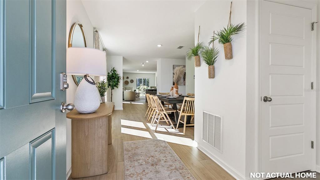 This is a rendering of an entryway leading into a dining area and living space — 73 FLAGSTICK LANE, BUNNELL, FL