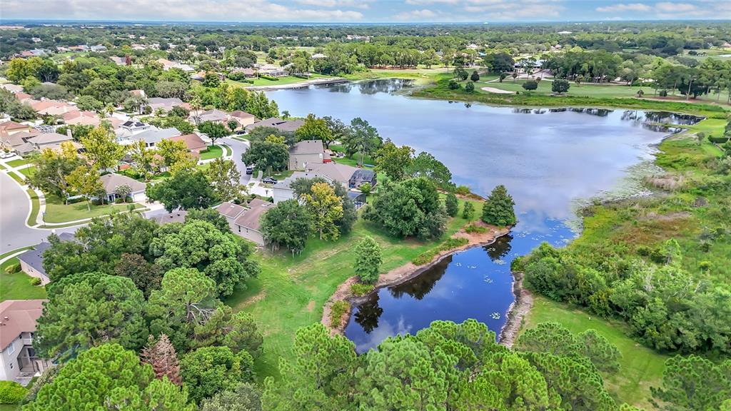 An aerial view shows a residential neighborhood bordering a large lake and a smaller pond — 949 PICKFAIR TERRACE, LAKE MARY, FL