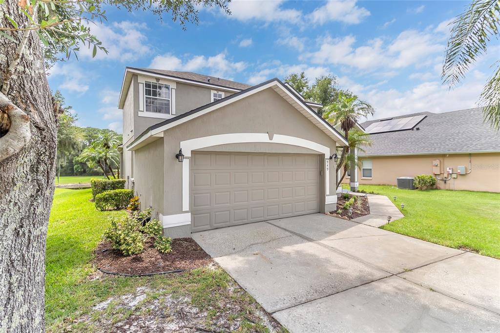 A two-story house with a beige stucco exterior and a two-car garage — 949 PICKFAIR TERRACE, LAKE MARY, FL