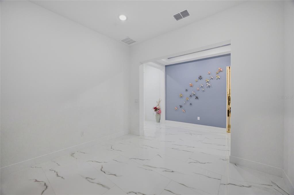 A covered patio with paver flooring, a screened wall, and a view of the backyard — 1515 VALIER POINT, ZEPHYRHILLS, FL
