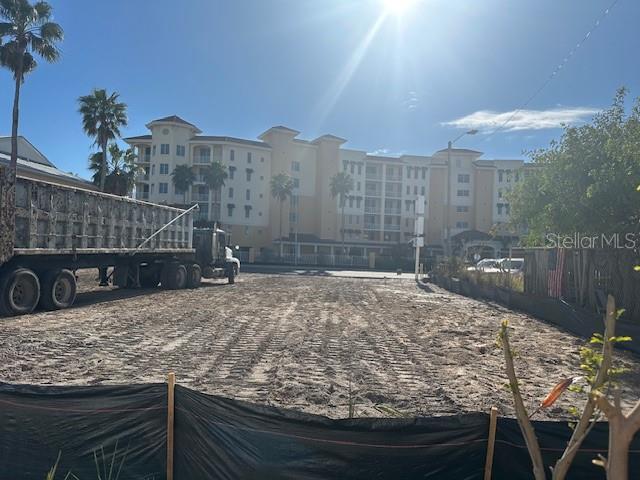 A large, cleared dirt lot sits in front of a multi-story residential building — 15227 GULF BOULEVARD, MADEIRA BEACH, FL