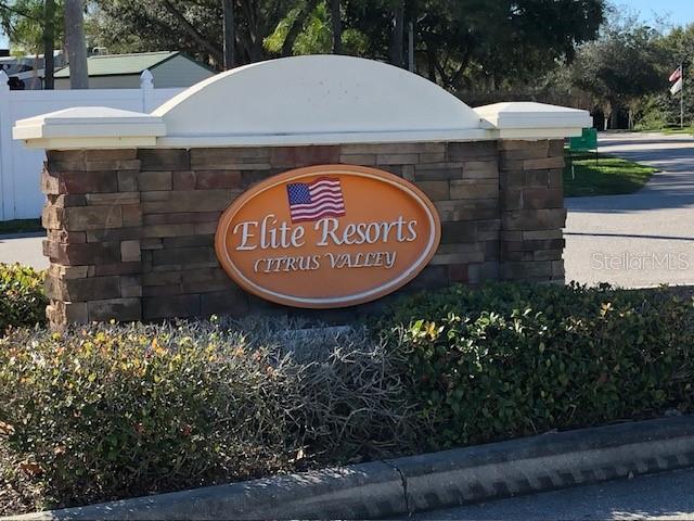 A stone monument sign for Elite Resorts Citrus Valley stands near a paved road — 2537 LEMONWOOD AVENUE, CLERMONT, FL