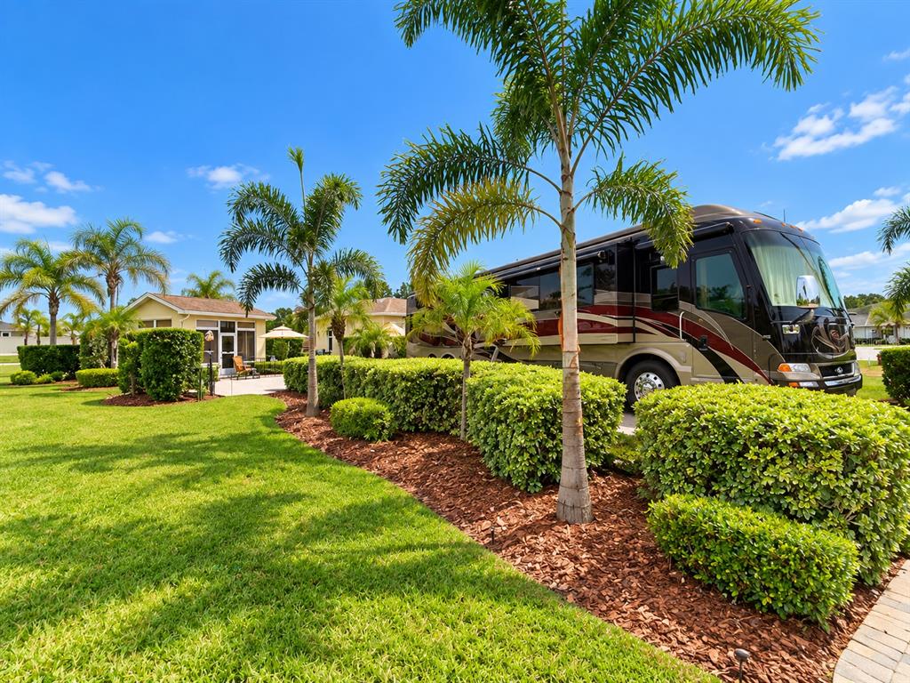 A small, detached building with a white door and large windows sits on a patio — 326 NOLANE LANE, POLK CITY, FL