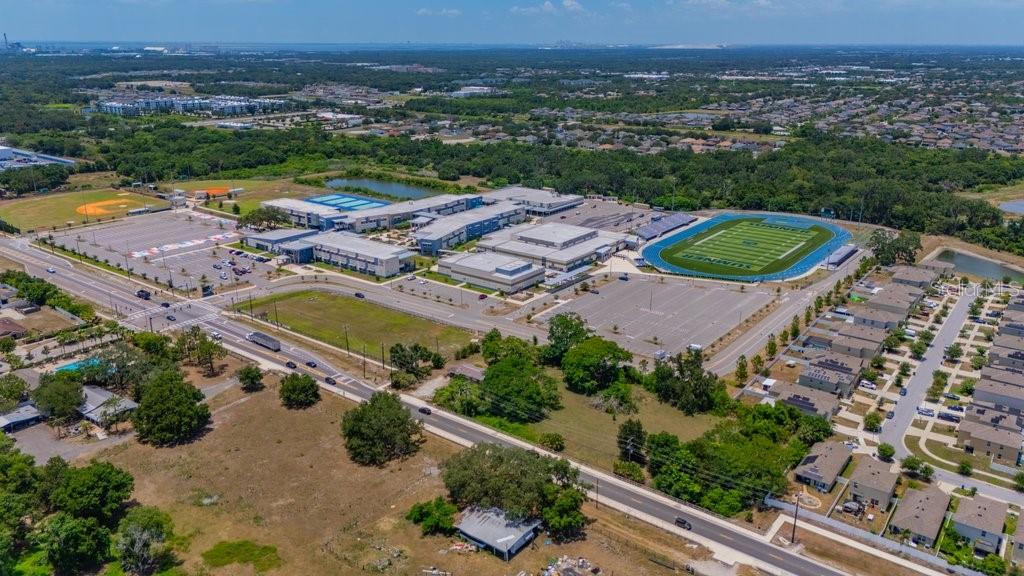 Aerial view of a large school campus featuring a football field and parking lots — 10912 672 HIGHWAY, RIVERVIEW, FL