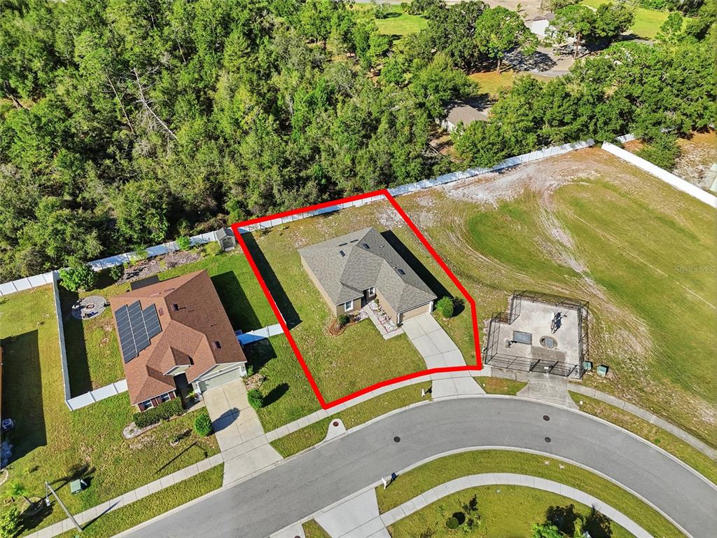 An aerial view shows a single-story house with a fenced yard on a cul-de-sac — 7878 TANBIER DRIVE, ORLANDO, FL