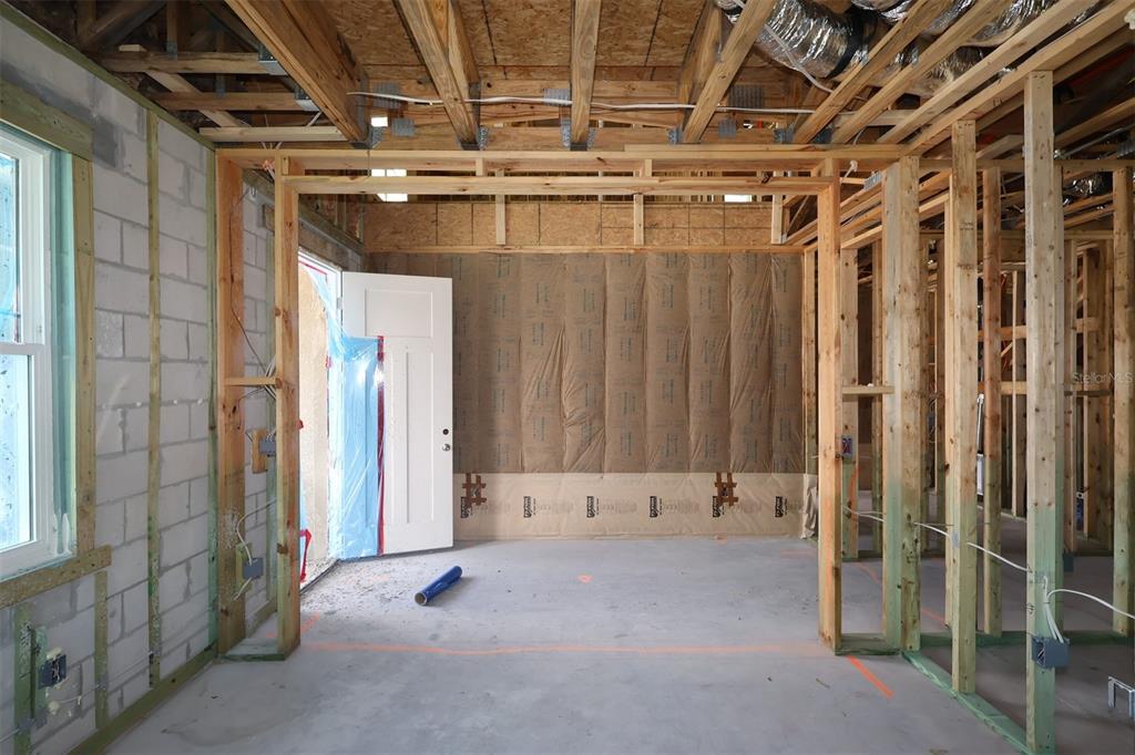 An interior view of a room under construction with exposed wood framing and insulation — 2873 SWEETGRASS LANE, ZELLWOOD, FL