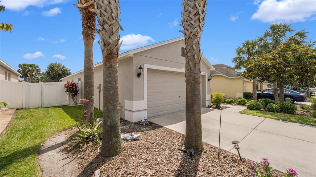 A beige house with a garage and two palm trees in the front yard — 7120 FOREST MERE DRIVE, RIVERVIEW, FL
