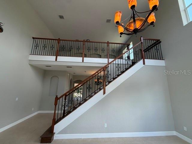 A two-story suburban house with a stone facade, palm trees, and a paved driveway — 3915 SHOREVIEW DRIVE, KISSIMMEE, FL