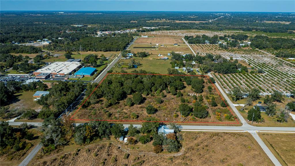 An aerial view shows a rectangular, tree-covered plot of land outlined in red near roads — SW CO RD 760A, ARCADIA, FL